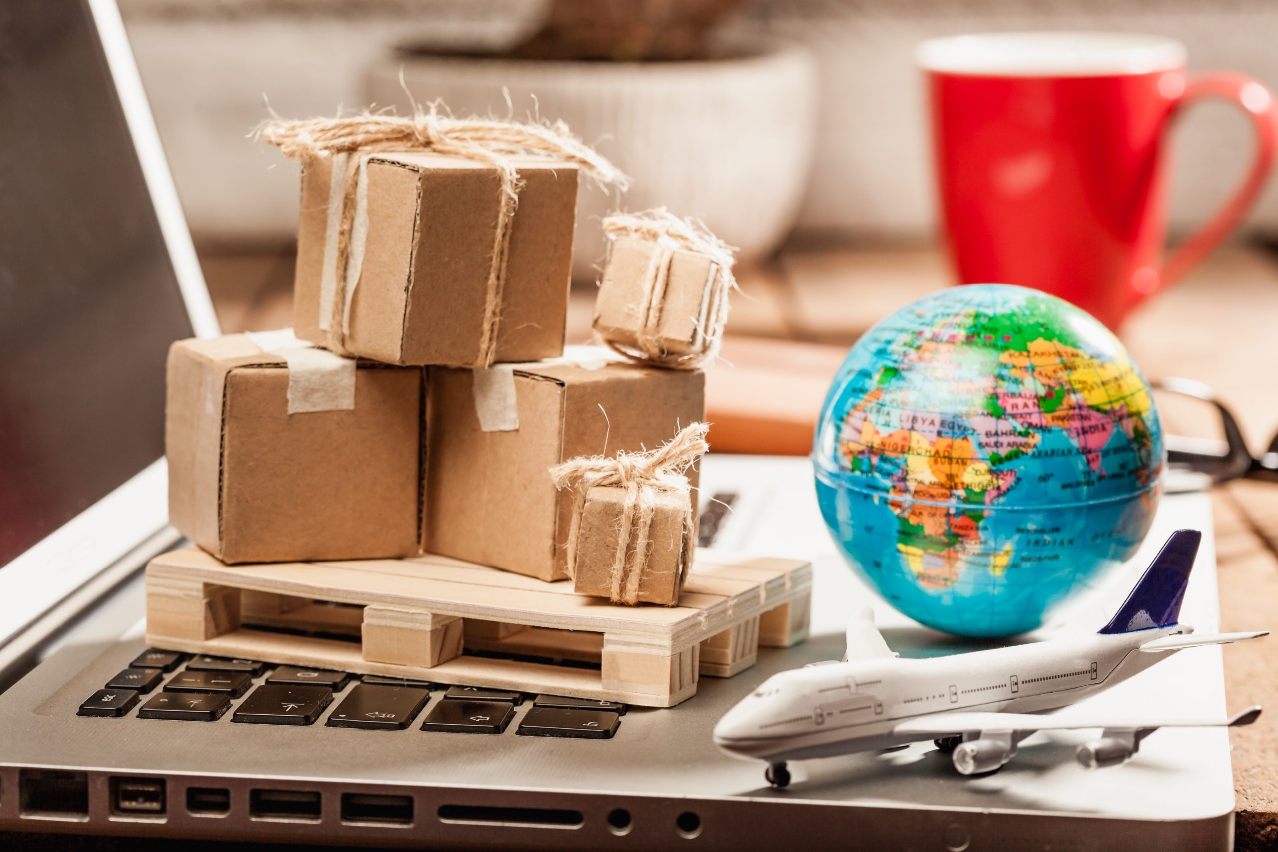 Carton boxes on computer as online shopping logistics concept